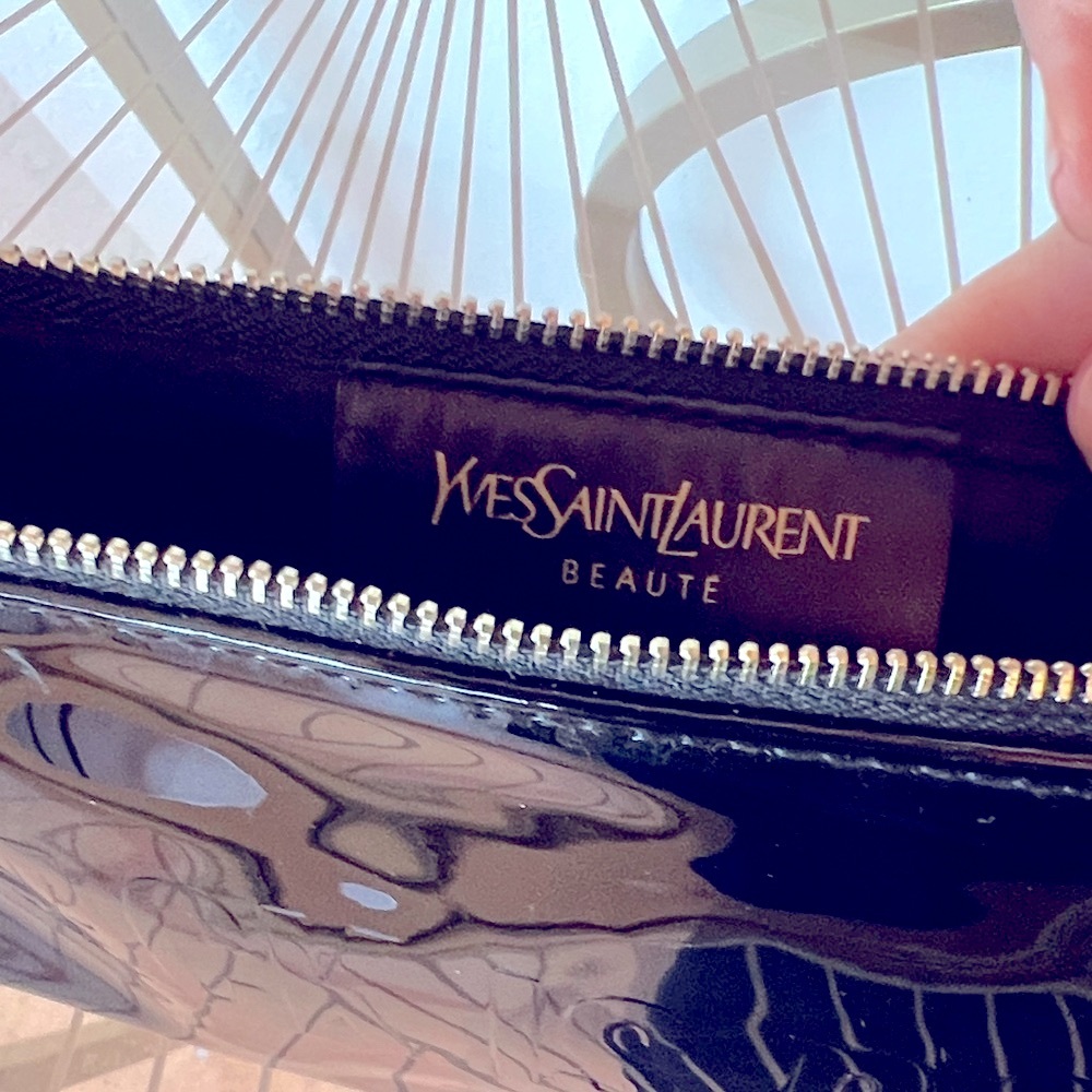 Yves Saint Laurent Black Cosmetic Bag with Gold Accents it reads “Black is Bold”